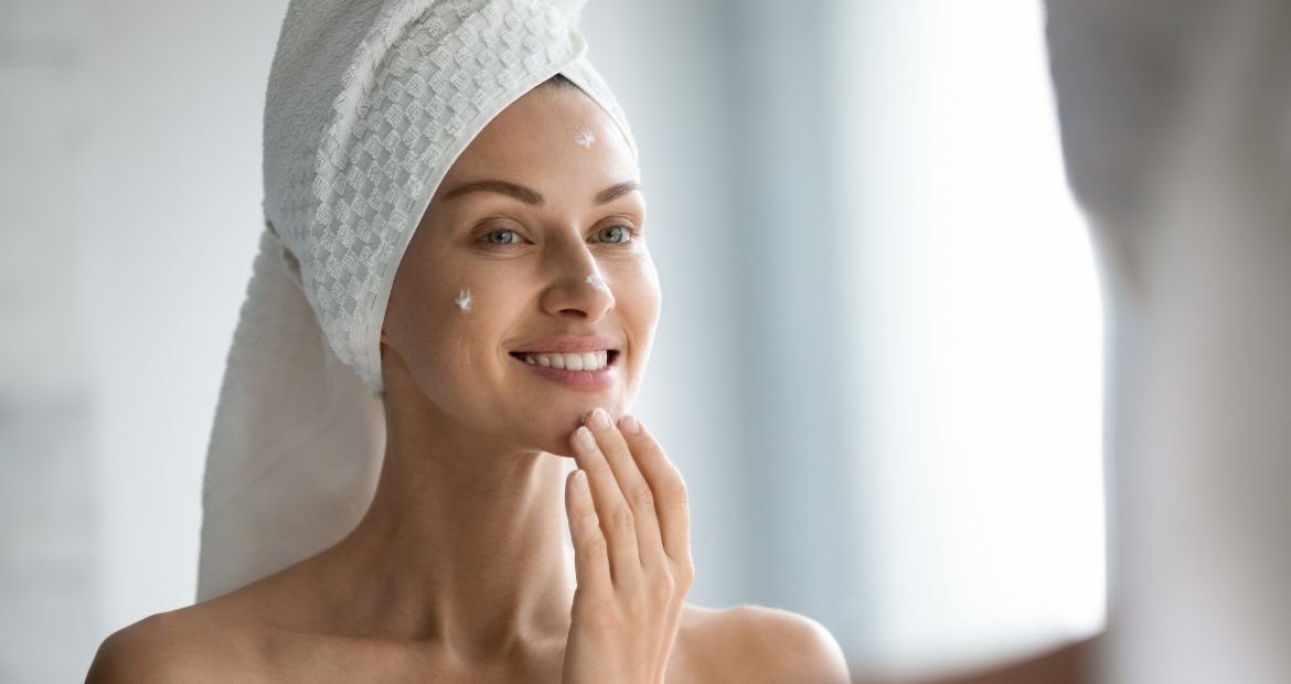 Senhora sorridente usa os benefícios do ácido kójico para clarear manchas no rosto